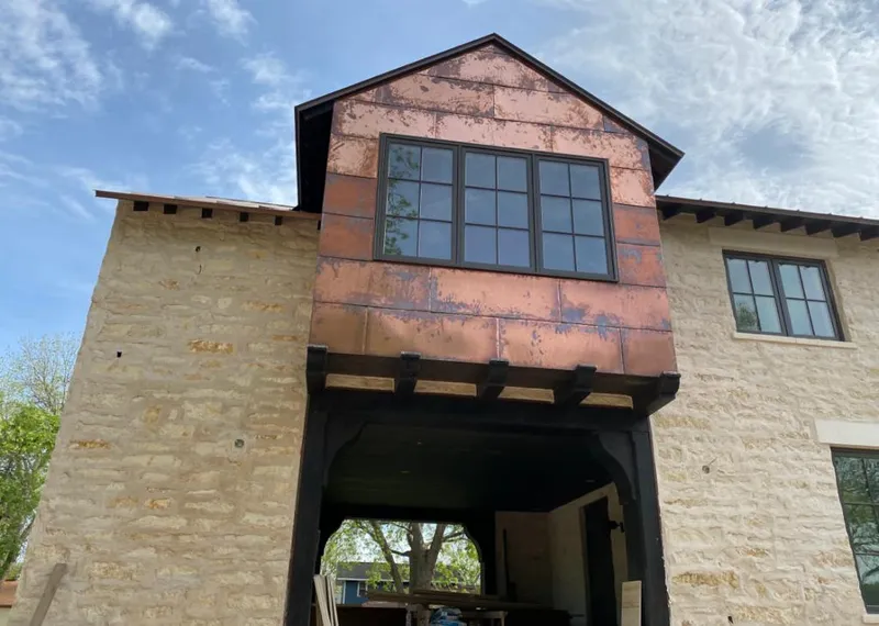 Copper metal panel facade on a stone building for Skylight Installation in Warrenton